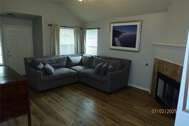 305 Duprie Dr, Brenham, TX 77833 - living room featuring dark wood-style floors, vaulted ceiling, and a tile fireplace