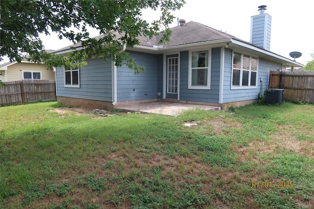 305 Duprie Dr, Brenham, TX 77833 - rear view of house featuring a chimney and a patio area