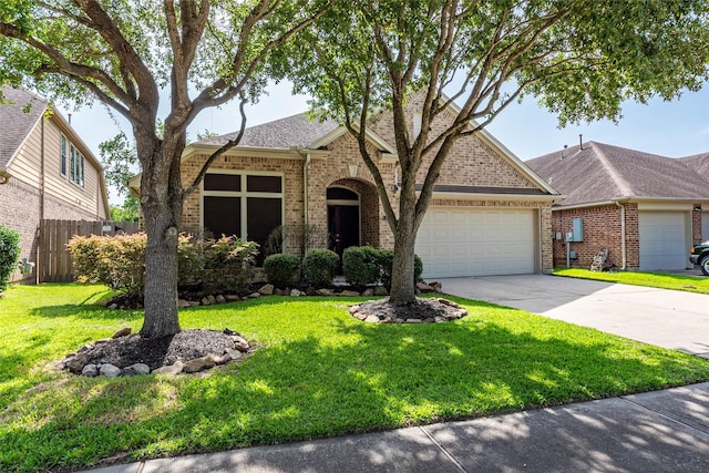 3211 Rock Brook Falls Ln, League City, TX 77573 - view of front facade with an attached garage, brick siding, driveway, and a shingled roof