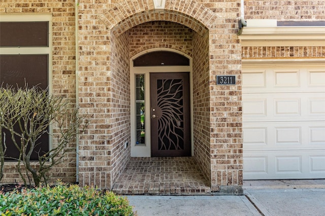 3211 Rock Brook Falls Ln, League City, TX 77573 - doorway to property featuring brick siding and a garage