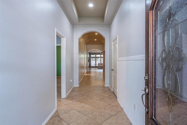 3211 Rock Brook Falls Ln, League City, TX 77573 - corridor featuring arched walkways, light tile patterned flooring, a raised ceiling, and recessed lighting