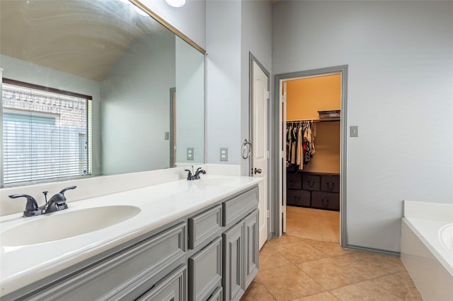 3211 Rock Brook Falls Ln, League City, TX 77573 - bathroom featuring double vanity, a garden tub, tile patterned floors, and a walk in closet