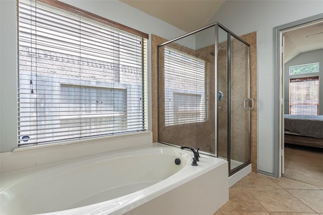 3211 Rock Brook Falls Ln, League City, TX 77573 - bathroom featuring a garden tub, connected bathroom, a stall shower, tile patterned flooring, and lofted ceiling