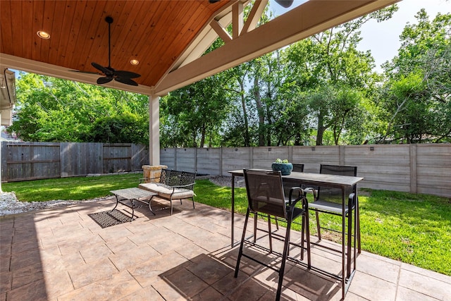 3211 Rock Brook Falls Ln, League City, TX 77573 - fenced backyard featuring ceiling fan, a patio, and outdoor dining space