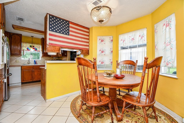17010 Kings Walk Ln, Houston, TX 77070 - dining room with a textured ceiling and light tile patterned floors