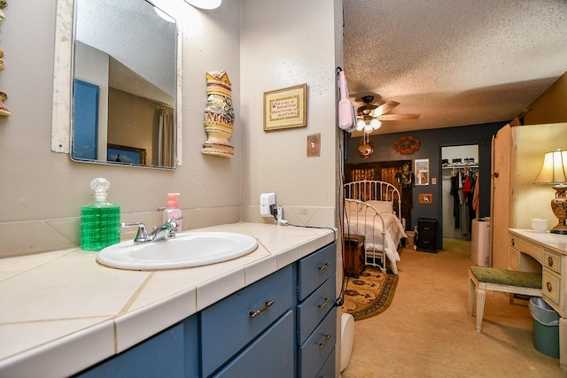 17010 Kings Walk Ln, Houston, TX 77070 - bathroom with vanity, a textured ceiling, and a ceiling fan
