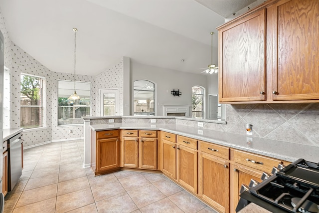 20907 Divellec Ln, Spring, TX 77388 - kitchen featuring light countertops, a peninsula, ceiling fan, lofted ceiling, and decorative backsplash