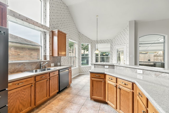 20907 Divellec Ln, Spring, TX 77388 - kitchen with appliances with stainless steel finishes, wallpapered walls, light countertops, light tile patterned floors, and decorative light fixtures