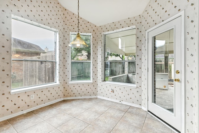 20907 Divellec Ln, Spring, TX 77388 - unfurnished dining area featuring wallpapered walls, vaulted ceiling, light tile patterned floors, and plenty of natural light