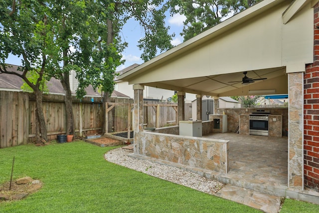 20907 Divellec Ln, Spring, TX 77388 - fenced backyard featuring exterior kitchen, a ceiling fan, and a patio