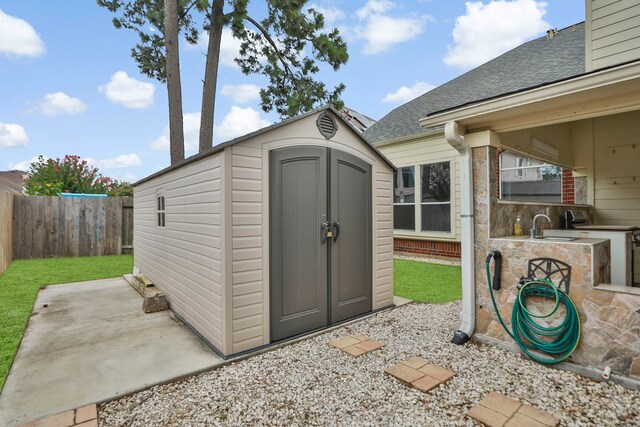 20907 Divellec Ln, Spring, TX 77388 - view of shed featuring an outdoor kitchen and a fenced backyard