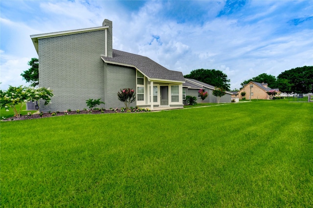 6606 Williams School Ct, Needville, TX 77461 - back of property featuring a yard, a chimney, and brick siding
