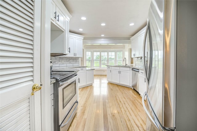 6606 Williams School Ct, Needville, TX 77461 - kitchen featuring stainless steel appliances, a peninsula, recessed lighting, light stone counters, and white cabinets