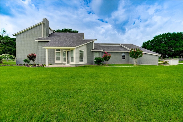 6606 Williams School Ct, Needville, TX 77461 - rear view of property featuring a lawn, a chimney, brick siding, and roof with shingles