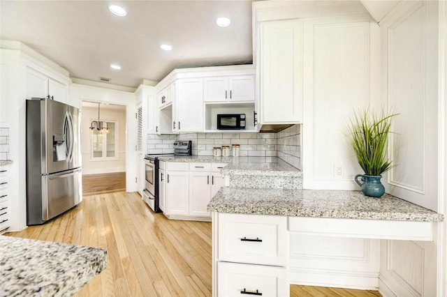 6606 Williams School Ct, Needville, TX 77461 - kitchen featuring stainless steel appliances, white cabinets, light wood-type flooring, tasteful backsplash, and recessed lighting