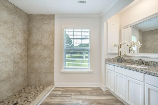 6606 Williams School Ct, Needville, TX 77461 - bathroom featuring vanity, wood finished floors, crown molding, and tiled shower