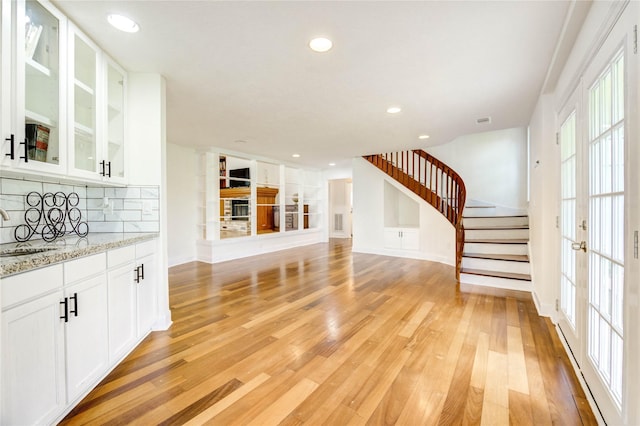 6606 Williams School Ct, Needville, TX 77461 - unfurnished living room featuring stairs, light wood-style flooring, and recessed lighting