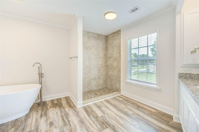 6606 Williams School Ct, Needville, TX 77461 - full bathroom with wood finished floors, a freestanding bath, ornamental molding, tiled shower, and vanity