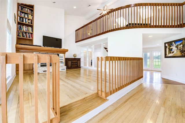 6606 Williams School Ct, Needville, TX 77461 - stairs featuring french doors, hardwood / wood-style floors, a towering ceiling, a ceiling fan, and recessed lighting