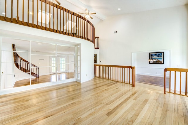 6606 Williams School Ct, Needville, TX 77461 - unfurnished living room featuring a ceiling fan, wood finished floors, beamed ceiling, high vaulted ceiling, and stairway