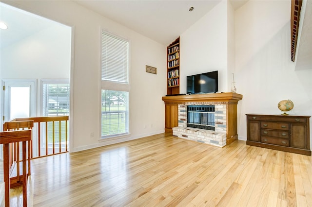 6606 Williams School Ct, Needville, TX 77461 - unfurnished living room featuring wood finished floors, high vaulted ceiling, and a fireplace