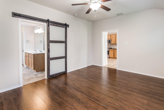 14039 Embry Stone Ln, Houston, TX 77047 - spare room with a barn door, ceiling fan, and wood finished floors