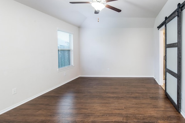 14039 Embry Stone Ln, Houston, TX 77047 - spare room with a barn door, a ceiling fan, vaulted ceiling, and dark wood-style floors