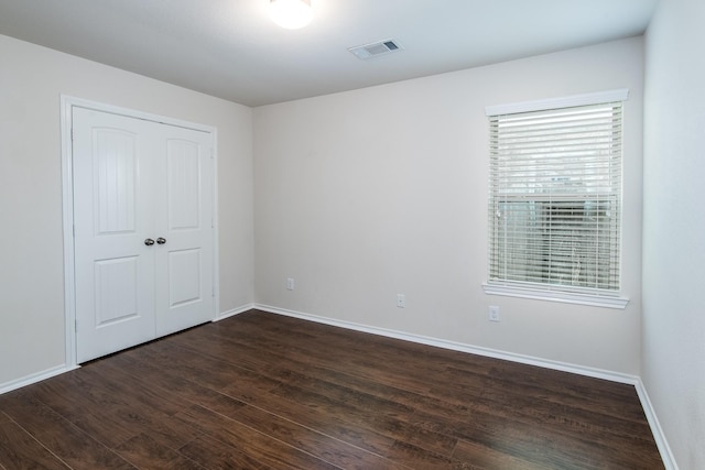 14039 Embry Stone Ln, Houston, TX 77047 - unfurnished bedroom featuring dark wood-style flooring and a closet