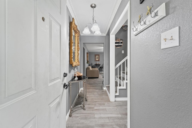 14018 Duncannon Dr, Houston, TX 77015 - foyer entrance featuring wood finished floors, a textured wall, a chandelier, and stairs