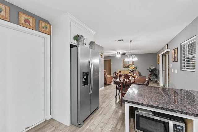 14018 Duncannon Dr, Houston, TX 77015 - kitchen featuring appliances with stainless steel finishes, light wood finished floors, white cabinetry, a ceiling fan, and hanging light fixtures