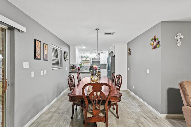 14018 Duncannon Dr, Houston, TX 77015 - dining room featuring light wood finished floors and a chandelier