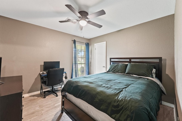 14018 Duncannon Dr, Houston, TX 77015 - bedroom with light wood-style floors, a textured wall, and a ceiling fan