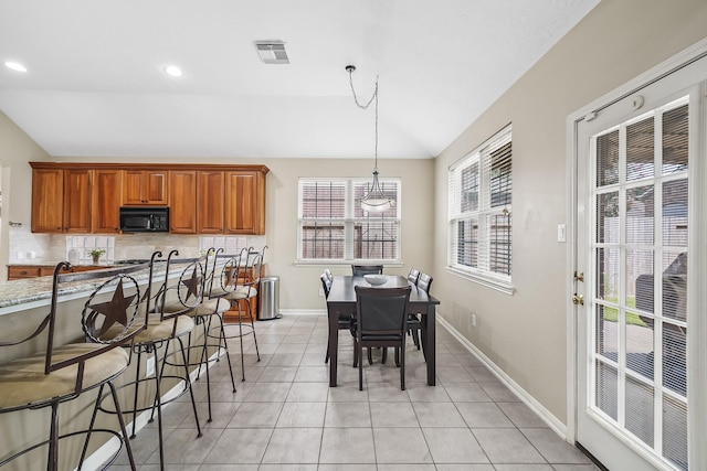 3343 Summerwood Ln, Pearland, TX 77584 - dining area with lofted ceiling, light tile patterned flooring, and recessed lighting