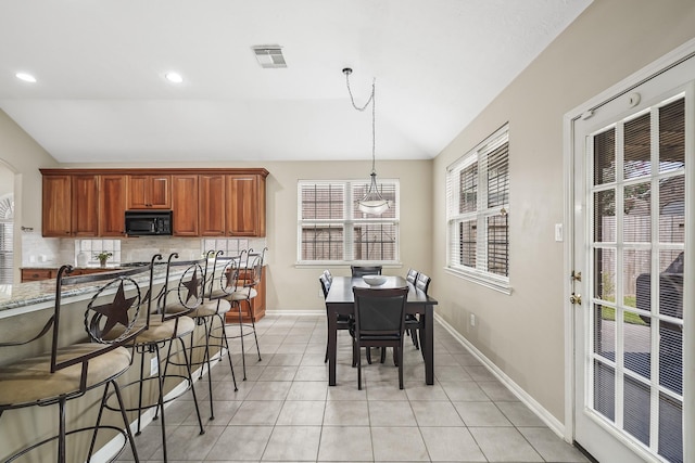 3343 Summerwood Ln, Pearland, TX 77584 - dining room featuring lofted ceiling, light tile patterned flooring, and recessed lighting