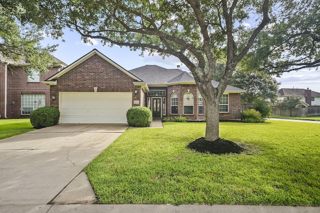 3343 Summerwood Ln, Pearland, TX 77584 - traditional-style house with brick siding, an attached garage, a front yard, concrete driveway, and roof with shingles