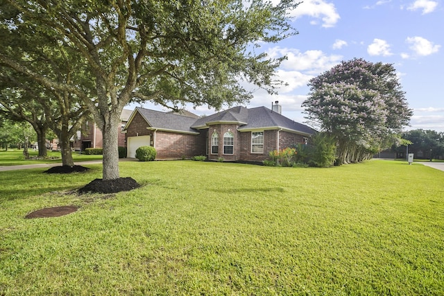 3343 Summerwood Ln, Pearland, TX 77584 - view of front of home with a garage, brick siding, a front lawn, and a chimney