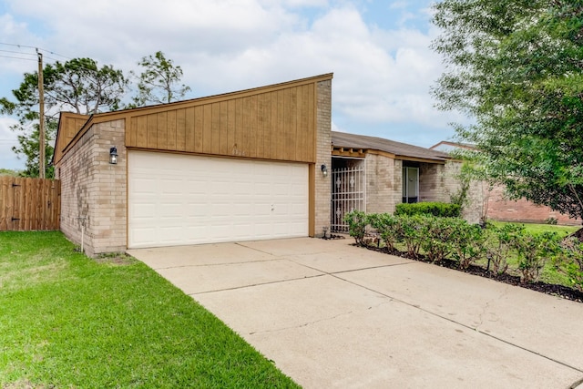 6306 Clayridge Dr, Houston, TX 77053 - mid-century home with a garage, driveway, and brick siding