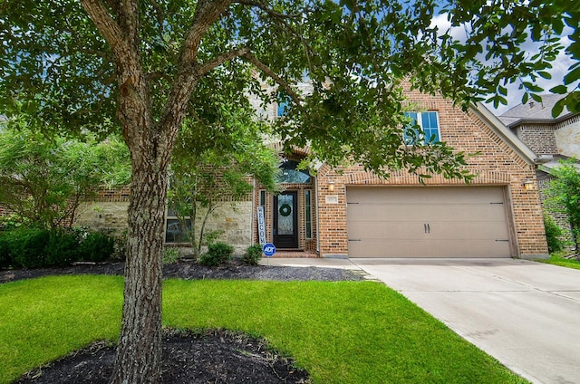 3707 Brampton Island Dr, Katy, TX 77494 - obstructed view of property featuring brick siding, a front lawn, driveway, and a garage