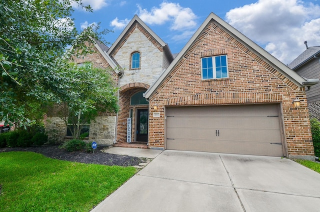 3707 Brampton Island Dr, Katy, TX 77494 - french country home with driveway, stone siding, brick siding, and a front yard