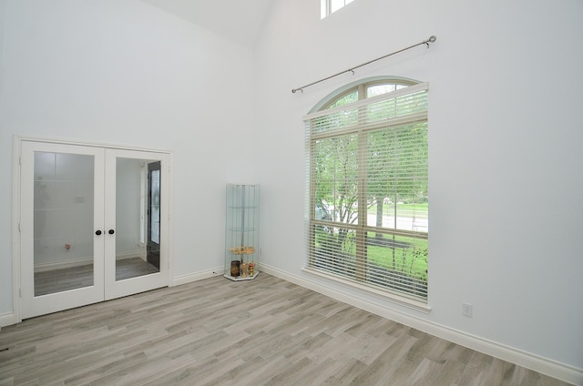 3707 Brampton Island Dr, Katy, TX 77494 - spare room featuring french doors, plenty of natural light, a towering ceiling, and light wood-style flooring