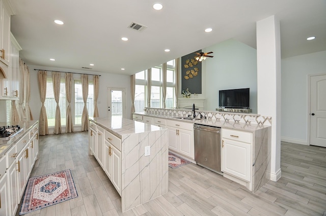 3707 Brampton Island Dr, Katy, TX 77494 - kitchen with stainless steel appliances, a ceiling fan, light wood finished floors, a kitchen island, and recessed lighting