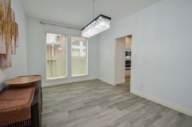 3707 Brampton Island Dr, Katy, TX 77494 - unfurnished dining area with a chandelier and light wood finished floors