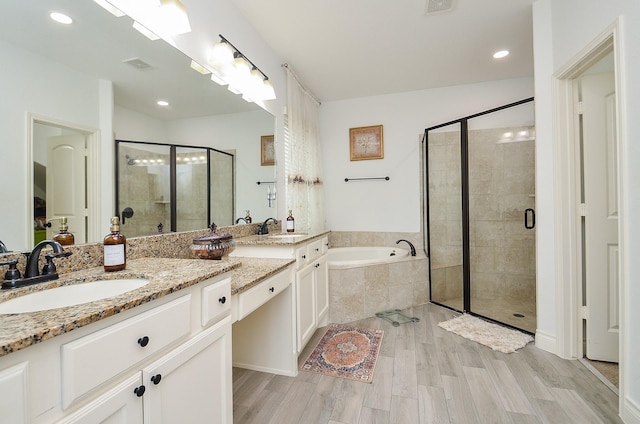 3707 Brampton Island Dr, Katy, TX 77494 - bathroom featuring double vanity, a shower stall, a bath, wood finished floors, and recessed lighting