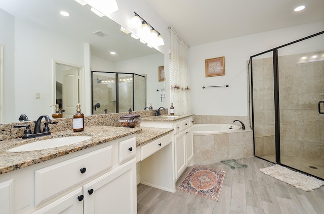 3707 Brampton Island Dr, Katy, TX 77494 - full bath featuring double vanity, a stall shower, a bath, wood finished floors, and recessed lighting