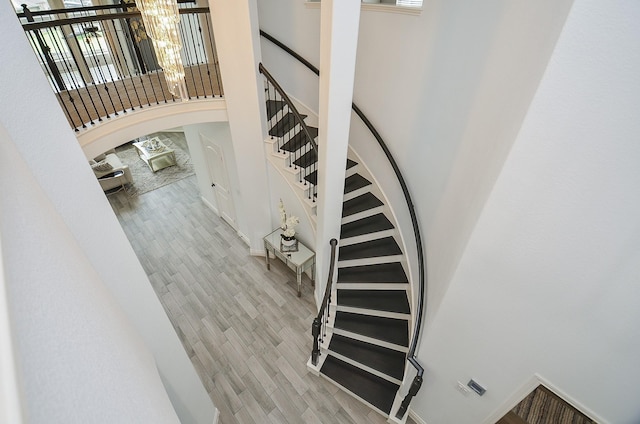 3707 Brampton Island Dr, Katy, TX 77494 - stairs with a high ceiling, wood finished floors, and a chandelier