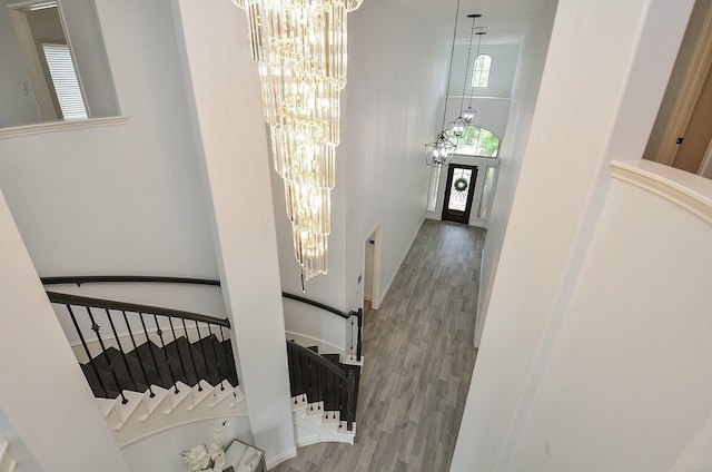 3707 Brampton Island Dr, Katy, TX 77494 - stairs featuring a chandelier, a high ceiling, and wood finished floors