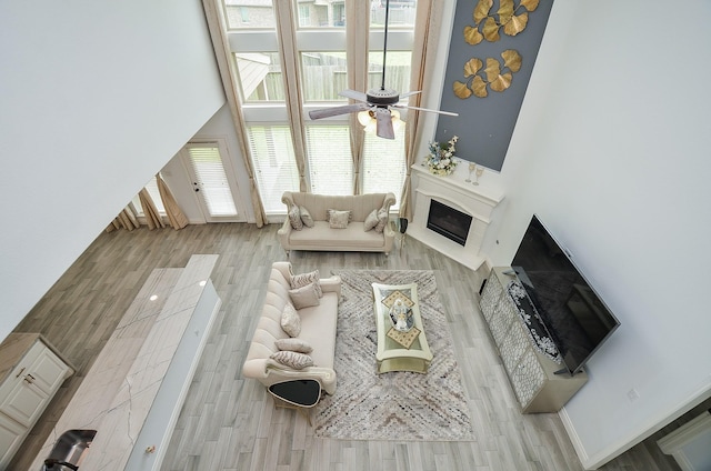 3707 Brampton Island Dr, Katy, TX 77494 - living area with ceiling fan, wood finished floors, and a fireplace with raised hearth