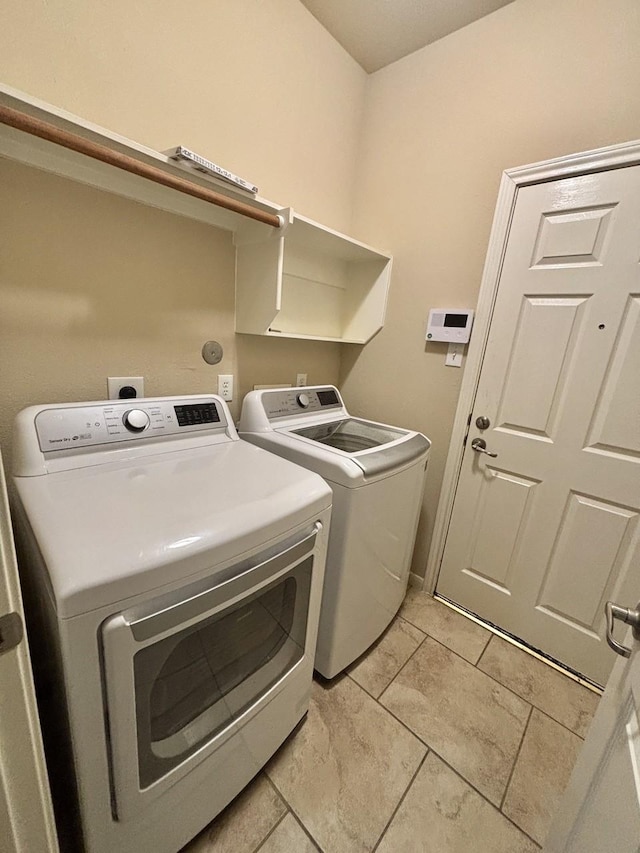 24514 Lake Path Cir, Katy, TX 77493 - laundry area with washing machine and clothes dryer and light tile patterned floors