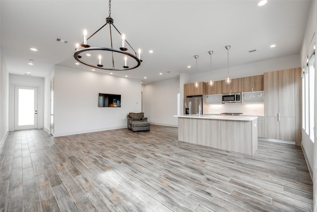 4402 Santorini Ln, Houston, TX 77045 - kitchen with appliances with stainless steel finishes, modern cabinets, light countertops, open floor plan, and light wood-style floors