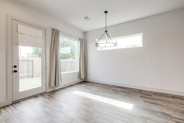 4402 Santorini Ln, Houston, TX 77045 - spare room with a chandelier and wood finished floors